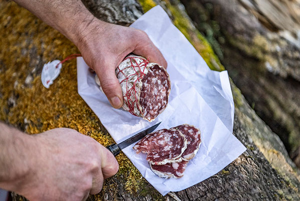 The traditional way to cut a cured sausage